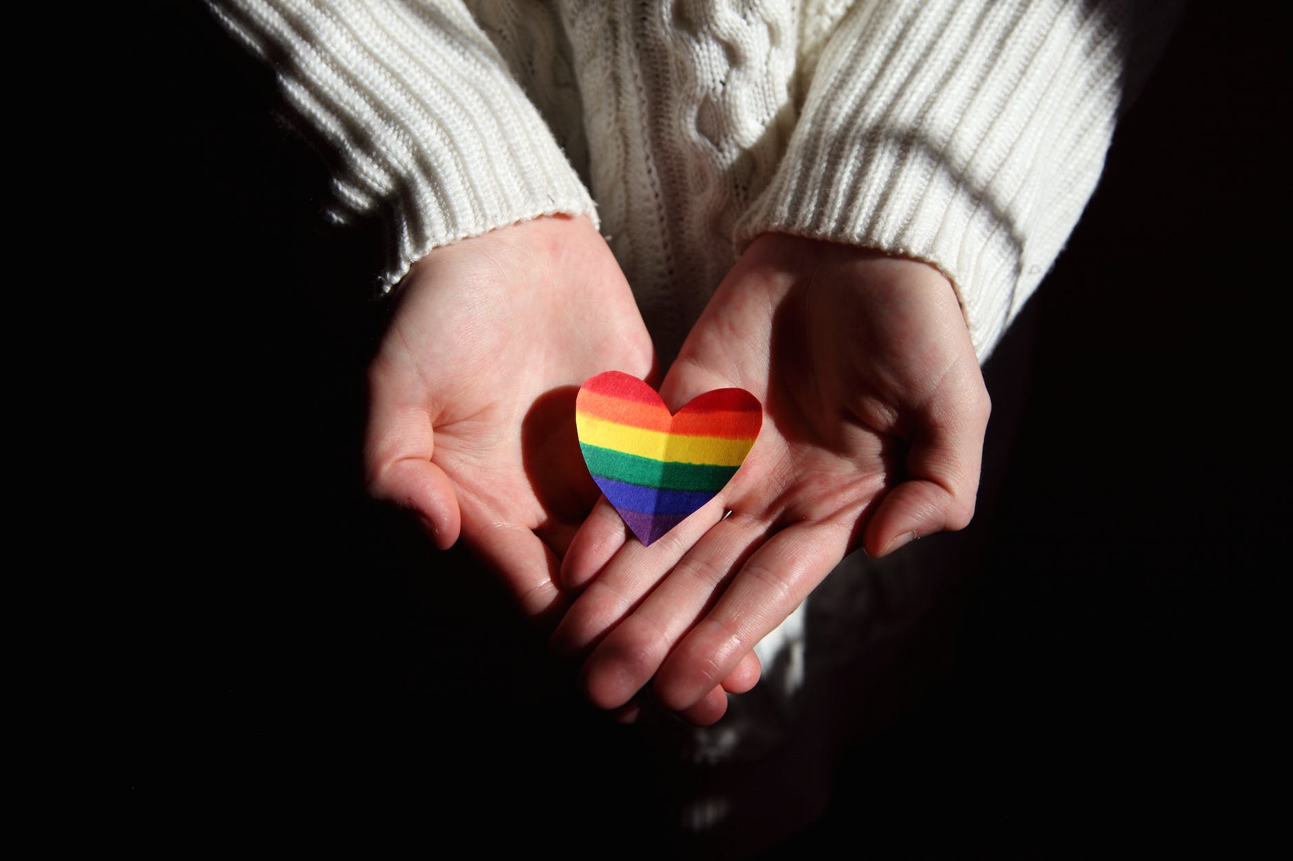 person holding colorful heart shaped