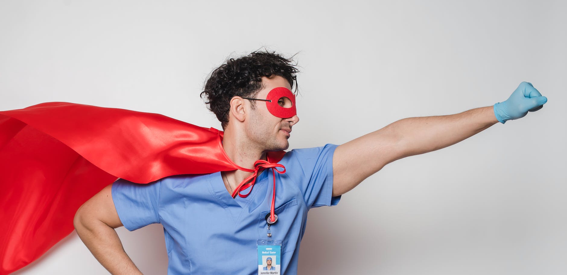 brave doctor in flying superhero cape with fist stretched