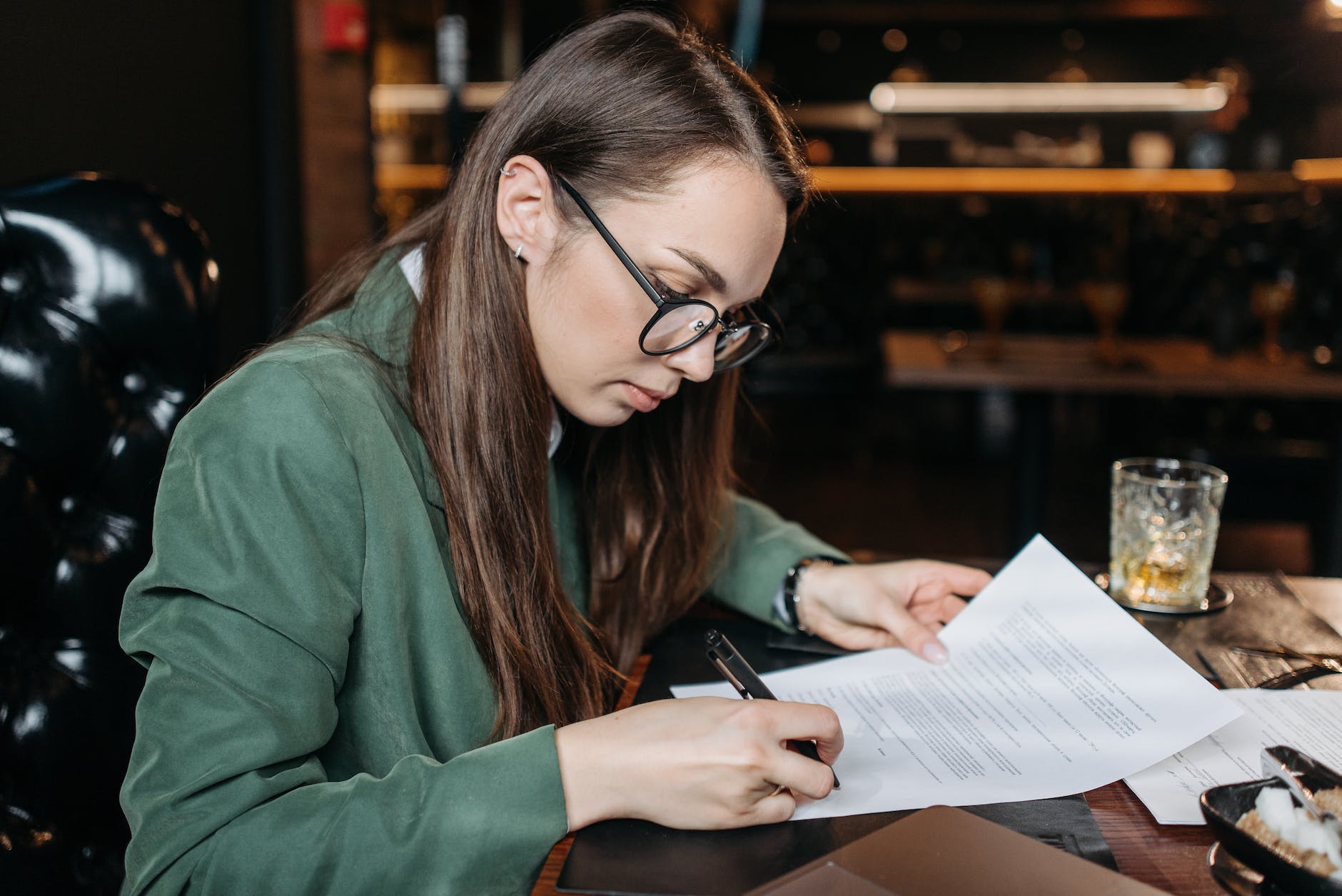 a woman signing a document